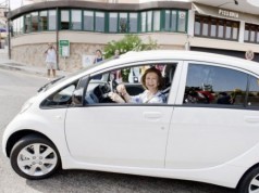 Queen Sofia of Spain behind the wheel of Peugeot's iON