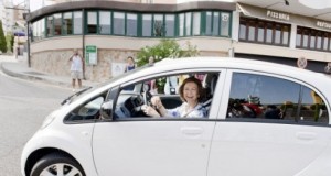Queen Sofia of Spain behind the wheel of Peugeot's iON